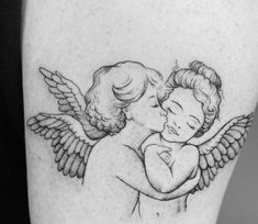 a tattoo with an angel hugging a child