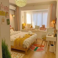 a bed room with a neatly made bed next to a desk and chair in front of a window