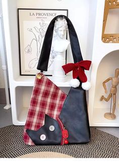 a purse with a cat on it and some other items in front of the bag