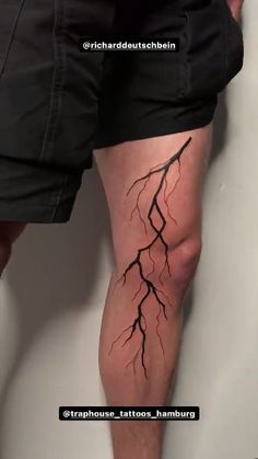 a man's legs are covered in black ink with a tree branch on it