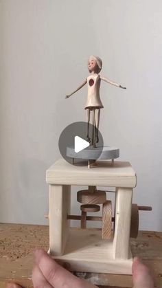 a person is playing with a toy on a table