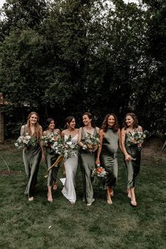 Bridesmaids in mismatched satin green bridesmaid dresses with the bride in a satin slip wedding dress Bridesmaid Dresses Garden, Mismatched Green Bridesmaid Dresses, Green Satin Bridesmaid Dresses, Sage Green Bridesmaid Dresses, Sage Green Bridesmaid, Garden Wedding Bridesmaids, Bridal Parties Colors