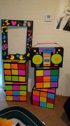 there are two boxes made to look like an old school disco dance machine and one is colorful