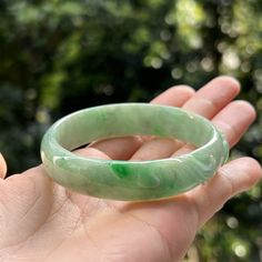 Jade Bangle Description --------------------------------- This jade bangle is 100% natural, untreated and undyed Type-A jadeite jade and is 100% handmade. Beautiful refreshing very light green base with bright green and faint yellowish green patches, purely created by our Mother Nature with delicate carvings of floral pattern, makes this bangle absolutely unique and collectible as an art piece. The sense of touch is cool. This piece has round shape with flat inner and round outer. Its flat inner would be fit your wrist perfectly. Simply but classic and well-matched for any outfit. This bangle is absolutely deserved to be addition to your collection or as a gift to your beloved one. **Note** The carving on the bangle is done to remove/ hide/ be less visible natural stone lines and imperfect Burmese Jade, Sense Of Touch, Yellowish Green, Jade Bangle, Jade Jewelry, Apple Green, Bright Green, Tri Color, Mother Nature