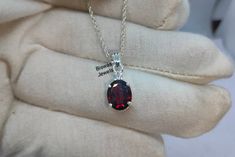 Natural Red Garnet Silver Necklace, Handmade Jewelry, 925 Sterling Silver, January Birthstone, Garnet CZ Necklace, Nice Birthday Gift For Her ★ Settings ☆ Metal - 925 Sterling Silver ☆ band Color - White ★ Main Stone ☆ Stone - Natural Red Garnet ☆ Size - 8×10 mm ☆ Shape - Oval ☆ Color Grade- AAA ☆ Side Stone - Round CZ Diamonds ★ Links : ☆ Check out my shop - https://www.etsy.com/shop/BiswasJewels?ref=seller-platform-mcnav ★ Notes : ☆ Don't forget to hit the favorite button in order to track the Oval Garnet Necklaces For Anniversary, Oval Garnet Necklace For Anniversary, Red Sterling Silver Jewelry For Birthday, Red Sterling Silver Necklaces For Birthday, Elegant Red Jewelry For Birthday, Elegant Red Jewelry For Birthday Gift, Garnet Necklace, Cz Necklace, January Birthstone