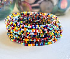 These dainty bracelet sets are perfect for layering, offering a fun and colorful addition to your boho jewelry collection with their stackable, stretchable design.*  Purchase multiples and save *  Made from tiny glass seed beads (2mm)  *  Available in multiple sizes *  Strung on durable beading elastic. *  Shipped to you in our recyclable packaging 🦋YOU MAY ALSO LIKE Daisy & Dahlia Bracelets https://etsy.me/4855PlF Seed Bead Bracelets https://bit.ly/stonesandpaper Tila Bracelets- https://etsy.me/3phAFHw  🦋DON'T SEE YOUR SIZE LISTED? The sizes we have listed are what we keep on hand to ship as quickly as possible We are happy to make a custom size.  Simply drop us a note to request a custom size Custom size requests are fulfilled based on supply availability 🦋 FIND THE PERFECT FIT * Meas Multicolor Tiny Beads Wrap Bracelet For Friendship, Multicolor Round Beads Wrap Bracelet For Friendship, Multicolor Stackable Friendship Bracelets For Beach, Multicolor Stackable Beaded Bracelets, Bohemian Multicolor Stackable Friendship Bracelets, Multicolor Stackable Beaded Bracelets For Friendship, Multicolor Stackable Friendship Bracelets With Round Beads, Multicolor Stackable Bracelets With Round Beads, Multicolor Stackable Stretch Bracelet For Festivals