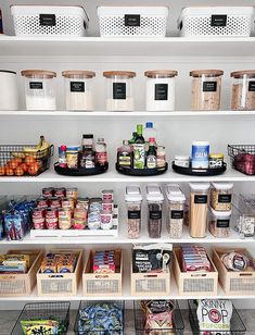 a pantry filled with lots of food and storage bins on top of white shelves