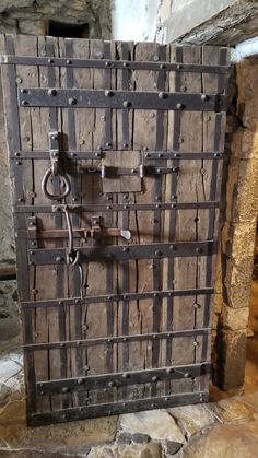 an old wooden door with iron bars on it