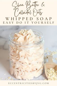 a glass jar filled with whipped soap next to a spoon