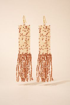 These earrings feature a rectangular beaded design that showcases intricate patterns and vibrant colors, reflecting the traditional Native American craftsmanship. The tassel detail adds movement and texture to the earrings, creating a playful and bohemian vibe. The hook closure ensures easy wear and a comfortable fit. Size Height: 4.25 in (10.8 cm)Width: 0.75 in (1.91 cm) Quality Made using sparkling high quality clear Austrian crystal rhinestones for the most dazzling sparkle, laid on a lightweight strong gold color metal alloy, with a thick, non-slip rubber backing to hold your earrings in place. ImportedE12365 Bohemian Rectangular Earrings With Dangling Beads, Bohemian Rectangular Dangling Bead Earrings, Bohemian Rectangular Beaded Earrings With Dangling Beads, Bohemian Rectangular Earrings With Colorful Beads, Multicolor Bohemian Beaded Rectangular Earrings, Multicolor Bohemian Rectangular Beaded Earrings, Bohemian Multicolor Rectangular Beaded Earrings, Bohemian Colorful Beaded Rectangular Earrings, Bohemian Gold Rectangular Beaded Earrings