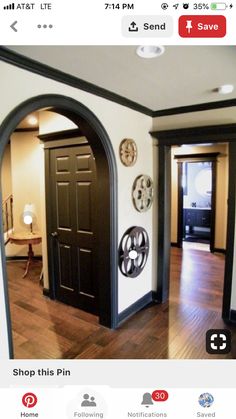 an open door is shown in the middle of a room with wood floors and white walls