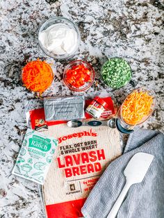 the ingredients to make lavash bread laid out on a marble counter top with utensils and napkins