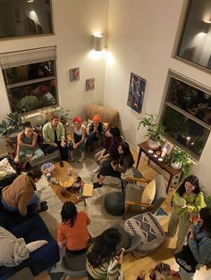 a group of people sitting in a living room together