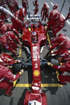 the ferrari team is preparing to take off from the pit area in preparation for the race