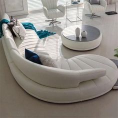 a living room filled with white furniture and lots of windows