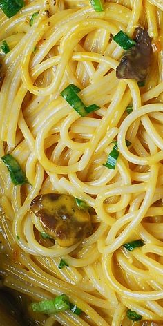 pasta with mushrooms and green onions in a bowl