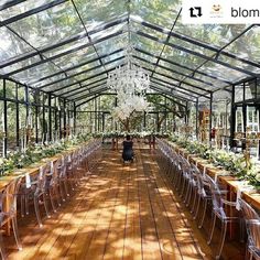 the inside of a greenhouse filled with lots of tables and chairs