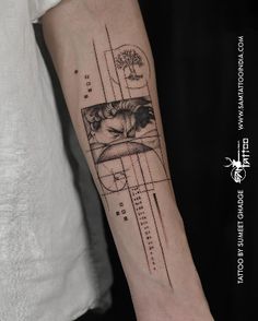 a man's arm with a tattoo on it that has an image of a cat