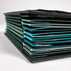 a stack of folders sitting on top of each other in front of a white background