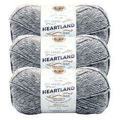 three skeins of gray yarn with the words heartland written on each ball