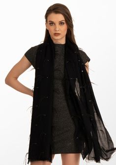 This black scarf is woven from the finest premium cashmere. It is a stunning head-turner adorned with a combination of black ostrich feathers, black sequin and contrasting silver Swarovski crystals scattered across the scarf. Meticulously hand crafted, this scarf is a classic combination of luxury and sophistication. The ostrich feathers add opulence, whilst the scattered sequin and Swarovski crystals bring a subtle yet dazzling allure. Whether draped casually for everyday chic or worn on specia Black Sparkly Scarf, Luxury Black Winter Scarves, Chic Black Scarves For Evening, Chic Black Scarf For Evening, Chic Black Evening Scarves, Chic Black Evening Scarf, Luxury Black Scarf For Fall, Luxury Black Scarf For Formal Occasions, Luxury Black Formal Scarves