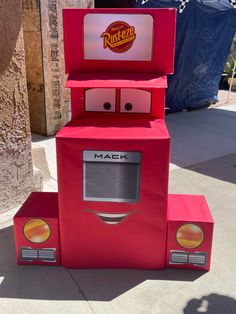 a red cardboard box that has some kind of machine on it's head and eyes