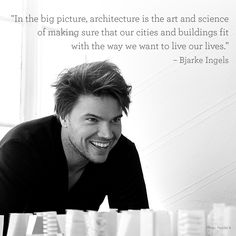 a man is smiling in front of stacks of books with a quote on the side