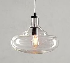 a clear glass light fixture hanging from a ceiling