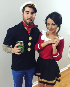 a man and woman dressed up in costumes posing for a photo with cans of beer