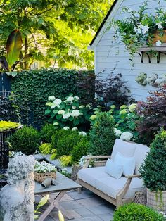 a patio with chairs and plants in it