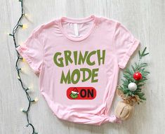 Grinch Mode On T-Shirt,Women Grinch Shirt, Grinch Christmas Sweater, Grinch Christmas Shirt, Grinch Christmas Gift,Christmas Pajamas Shirt Welcome to MamaBearApparell! I am a professional designer and a Mama of twins. As a professional designer, I am delighted to offer you designed t-shirts that your entire family will love and cherish, making your special moments even more beautiful. We are working to provide you with high-quality soft t-shirts and sweatshirts with trendy designs. We prioritize quality materials and stunning designs to offer you the best service possible. Our handmade items will be the perfect choice for your celebrations, vacations, graduations, or birthday & wedding parties and holidays (such as Christmas, Thanksgiving ..)  Discount available on bulk orders! Feel free t Grinch T Shirt Ideas, Grinch Christmas Sweater, Grinch Christmas Shirt, Pajamas Shirt, New Years Eve Day, Grinch T Shirt, Grinch Shirt, Grinch Shirts, Grinch Christmas