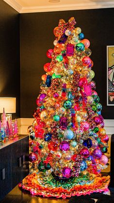 a brightly colored christmas tree in a living room