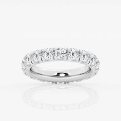 a white gold wedding band with round cut diamonds on the top and bottom half of it