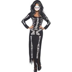 a woman wearing a skeleton costume with long black hair and white makeup, standing in front of a white background