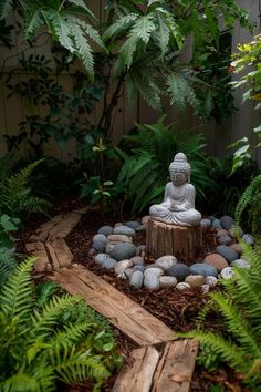 a buddha statue sitting on top of a wooden stump in a garden filled with plants