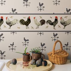 chickens and roosters are painted on the wall next to pots with plants in them