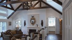 a living room filled with furniture and a fire place in the middle of a room