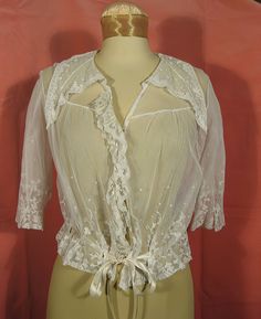 "Lovely Edwardian cotton net lace blouse that's about as feminine as it gets. It ties at the bottom with vintage silk ribbon, and the lace edged collar is composed of three points. The blouse has been soaked and cleaned, but there are some very small scattered brownish spots and pinholes under the back collar that are not very noticeable and don't really detract from the delicate image. Otherwise, the blouse is in very good wearable condition. A size small, the measurements are approx. 17\" acro Vintage Lace Top With Lace Trim For Formal Events, Vintage Formal Lace Top With Lace Trim, Edwardian Wrapper, Vintage Lace Blouse With Ruffled Collar, Vintage Lace Top For Formal Occasions, Victorian Blouse With Lace Collar, Victorian Lace Blouse With Lace Trim, Victorian Blouse With Lace Collar For Daywear, Vintage Wedding Blouse With Lace Collar