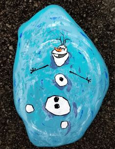 a painted rock with an image of two frozen snowmen on it, and one is looking up at the sky