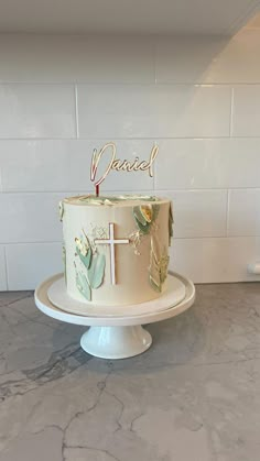 a cake that is sitting on top of a table in front of a white tile wall