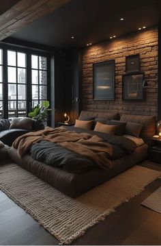 a large bed sitting in the middle of a living room next to a brick wall