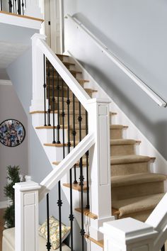 the stairs in this house are made of wood and wrought iron, with handrails