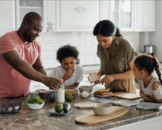 a family is preparing food in the kitchen