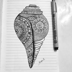 a drawing of a seashell on lined paper with a pen next to it,