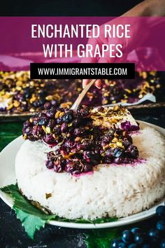 a plate with rice and blueberries on it next to a pan filled with grapes