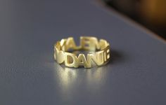 cute dainty names ring ♥ the design of this personalized names ring can accommodate from 15-20 letters, which means you can have one or more names or words in one ring as long as the total number of characters are max. 20 :) for example; you can have just one name or two or gather all your kids' names and have them in one ring material options: 9k solid gold 14k solid gold 925 sterling silver rose gold plated over silver 14k gold plated over silver size: we offer sizes from 3 to 10 to order: ♡ p Nameplate Ring As Gift, Nameplate Rings Suitable For Gifts, Personalized Engraved Yellow Gold Ring With Name, Personalized Engraved Name Ring In Yellow Gold, Gold Rings With Custom Text For Anniversary, Personalized Name Yellow Gold Rings, Personalized Yellow Gold Rings With Name, Personalized Initial Ring With Custom Name, Custom Text Gold Rings For Anniversary