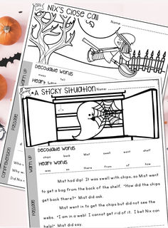 two halloween worksheets with pumpkins and other items on the table next to them