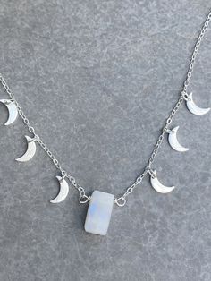 "Moonstone intensifies your feminine goddess energy within. Moonstone is used as a stone of the moon to call in abundance every day. Abundance is always here. The crescent moon means 'to bring forth'. A powerful duo of moon symbols, this necklace channels your divine feminine. I dreamed about this necklace and now, here it is. You can't take your eye off her. She dances as you move, all her little moons sparkling and shining as you spread your light. Wear it and channel abundance in every moment Bohemian Moonstone Jewelry With Moon Phase Detail, Bohemian Moonstone Jewelry With Moon Phase, Celestial Moon Jewelry For Meditation, Moonstone Jewelry With Moon Charm For Meditation, Celestial Moon-shaped Jewelry For Meditation, Magical Moon Phase Pendant Necklace, Magical Moon Shaped Sterling Silver Necklace, Magical Moon-shaped Sterling Silver Necklace, Bohemian Sterling Silver Moon Charm Necklace