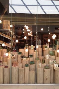 a store front with many wooden boxes and lights in it's window display area