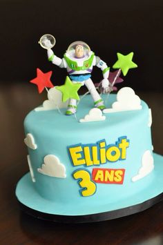 a birthday cake with an image of buzz lightyear on top and stars around it